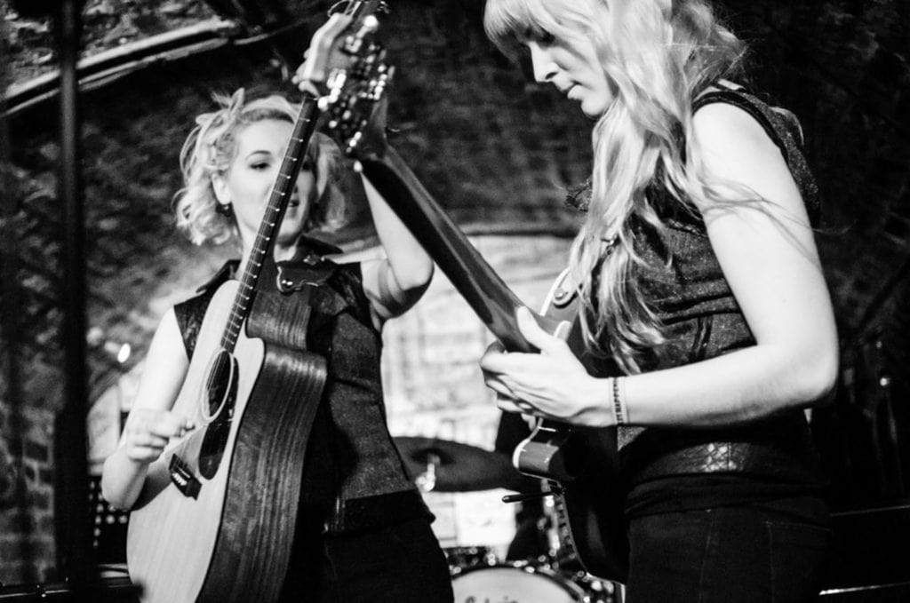 B/W photo of MonaLisa Twins playing guitar solos at the Cavern Club