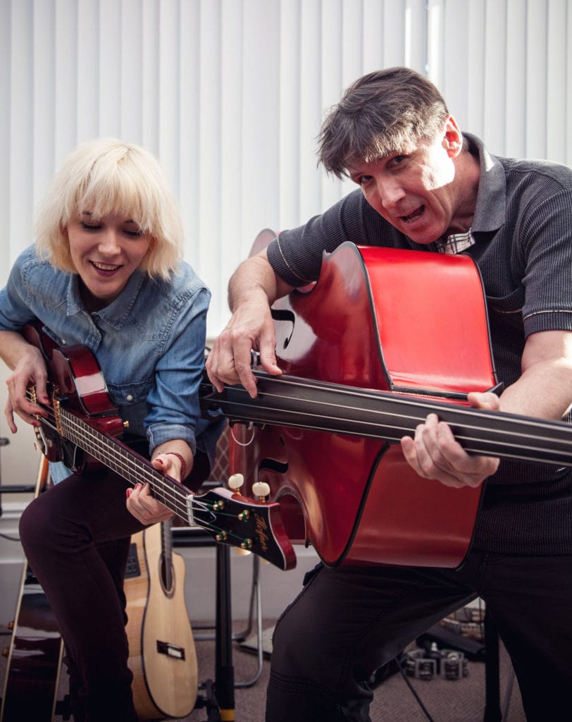 Mona and Dad Rudi duelling their red Höfner e-bass and their red Chadwick double bass